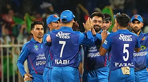 X/Afghanistan Cricket Board : Rashid Khan (centre) celebrates a wicket with teammates during the second Afghanistan vs Ireland T20I match in Sharjah on Sunday (March 17, 2024).