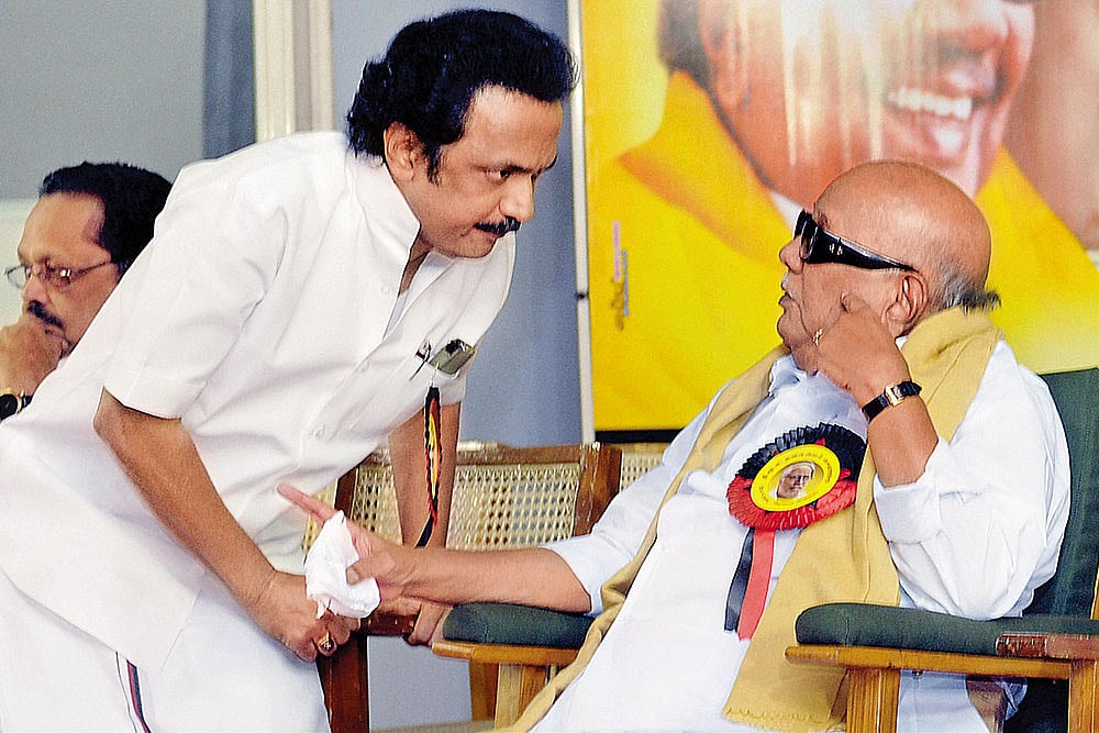 Photo: PTI : DMK Stalwarts: M K Stalin with his father M Karunanidhi in Coimbatore in 2011