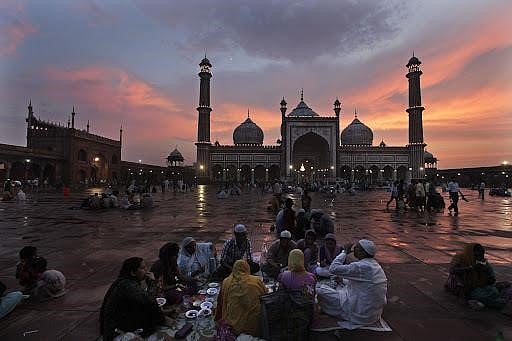 People enjoying the sunset at the Jama Masjid.
