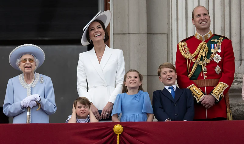 Queen Elizabeth II, Prince Louis, Kate, Duchess of Cambridge, Princess Charlotte, Prince George and Prince William gather on the balcony of Buckingham Palace, London, Thursday, June 2, 2022 as they watch a flypast of Royal Air Force aircraft pass over. 