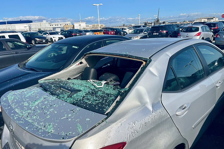 Damaged Car After United Airlines Flight Loses Tire - Haven Daley/ AP