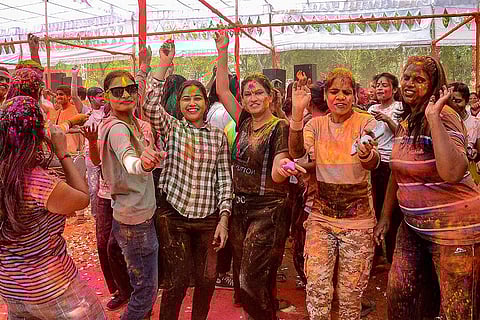 Police personnel celebrate Holi