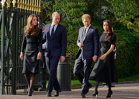 Britain's Prince William, second left, Kate, Princess of Wales, left, Britain's Prince Harry, second right, and Meghan, Duchess of Sussex view the floral tributes for the late Queen Elizabeth II outside Windsor Castle, in Windsor, England on Sept. 10, 2022.