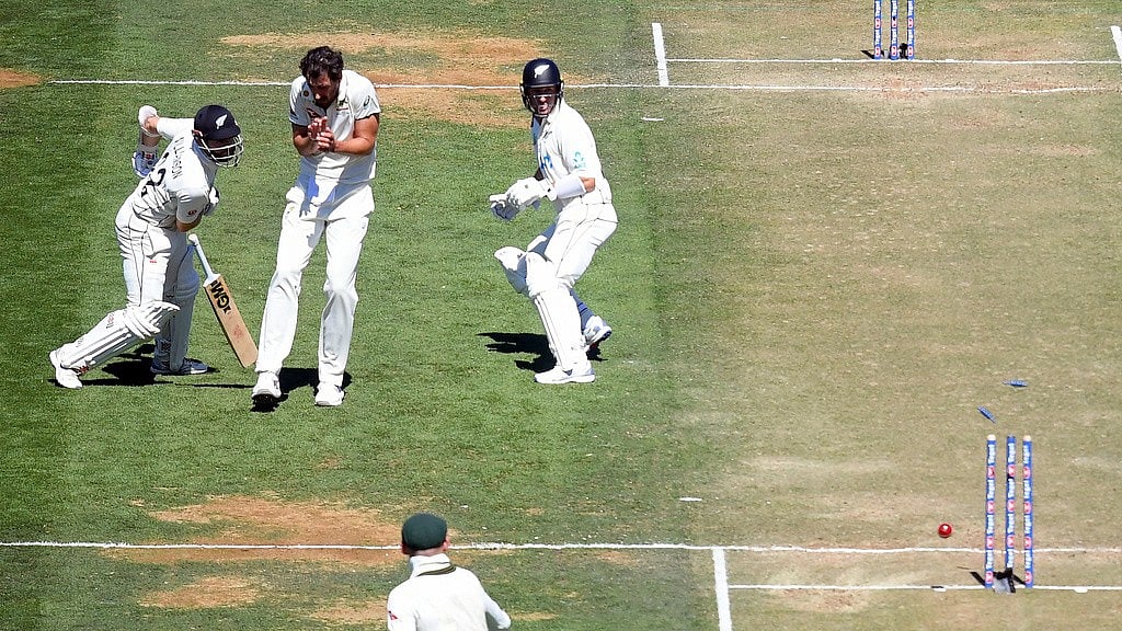 Kerry Marshall/Photosport via AP                   : Australia's Mitchell Starc, second left, flinches after New Zealand's Kane Williamson, left, and Will Young collide on the second day of their first Test match in Wellington on March 1, 2024.
