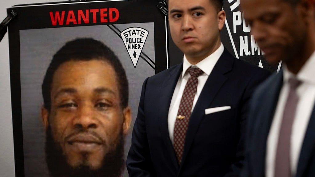 AP : A portrait of Jaremy Smith, 32, is displayed beside U.S. Attorney for New Mexico Alexander Uballez, second right, on Saturday, March 16, 2024, as Public Safety Secretary Jason Bowie gives a briefing following the death of New Mexico State Police officer Justin Hare, in Albuquerque.
