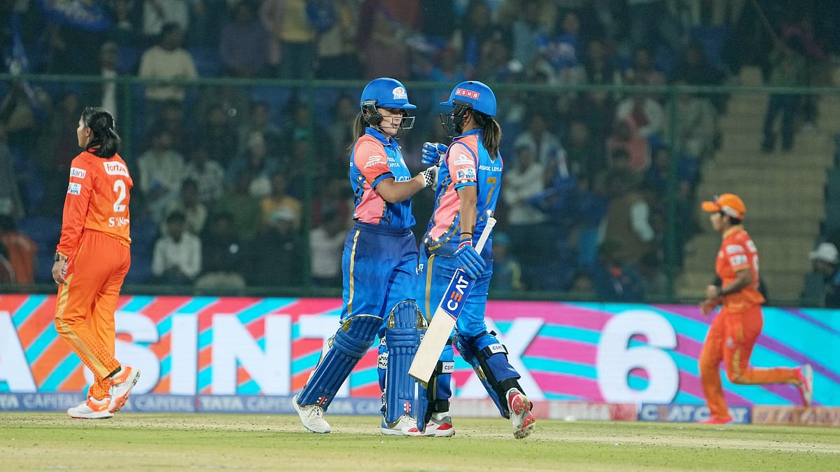 Photo: PTI : Mumbai Indians' captain Harmanpreet Kaur with Amelia Kerr during her innings against Gujarat Giants in WPL 2024.