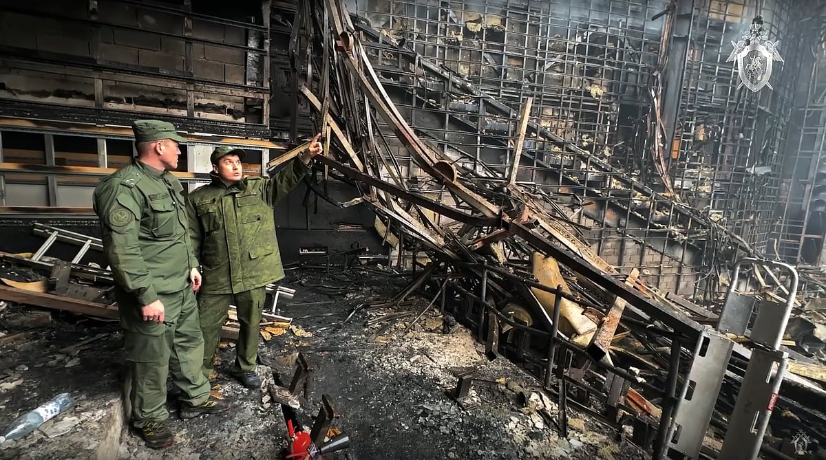 (Investigative Committee of Russia via AP) : Investigators from the Investigative Committee of Russia examine the burned concert hall after an attack on the building of the Crocus City Hall 