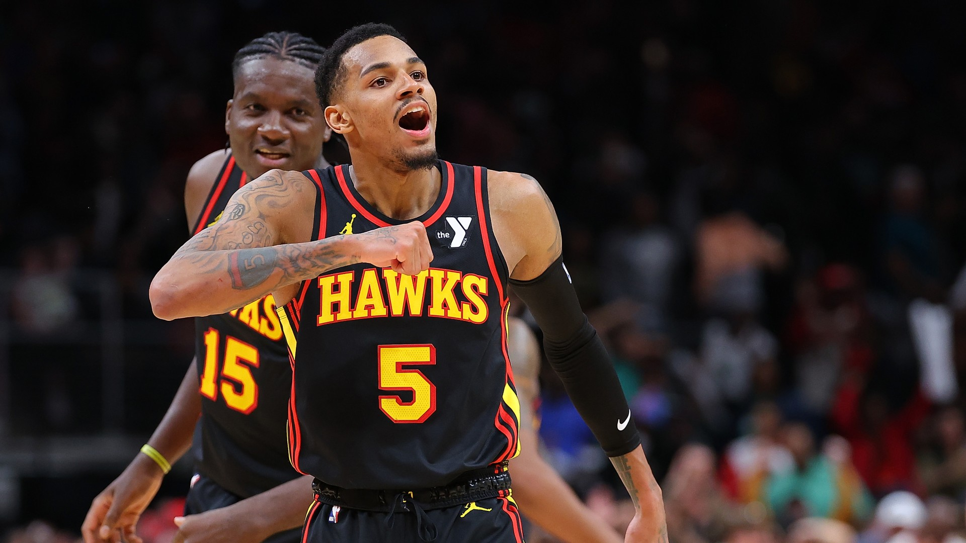 Dejounte Murray #5 of the Atlanta Hawks reacts after hitting the game-winning basket during overtime against Jrue Holiday #4 of the Boston Celtics at State Farm Arena on March 28, 2024. - null