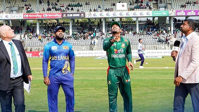 (Photo: X| Sri Lanka Cricket)  : Captains Najmul Hossain Shanto (second from right) and Charith Asalanka (third from right) at the toss for the third T20I between Bangladesh and Sri Lanka in Sylhet on March 9, Saturday. 