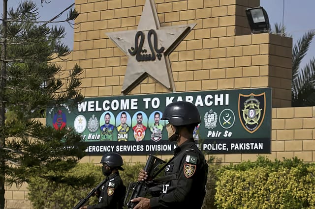Pakistan police commandos stand guard outside the National Stadium in Karachi, during a training session of the Pakistan cricket team. - File
