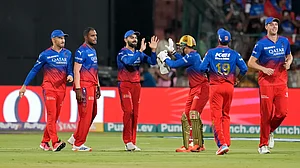 AP Photo/Aijaz Rahi : Royal Challengers Bengaluru's Virat Kohli celebrates with teammates after taking the catch to dismiss Punjab Kings' captain Shikhar Dhawan during the Indian Premier League match between Royal Challengers Bengaluru and Punjab Kings in Bengaluru.