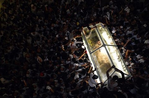 A figure representing Jesus surrounded by crowd in Phillipines.