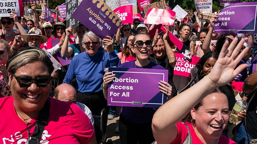 AP : Protesters cheer during a Planned Parenthood rally in support of abortion access outside the U.S. Supreme Court, April 15, 2023, in Washington.