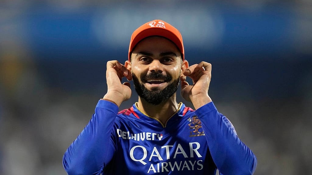 AP/Rajanish Kakade : Virat Kohli reacts to the crowd during the Indian Premier League 2024 match between Mumbai Indians and Royal Challengers Bengaluru at the Wankhede Stadium.