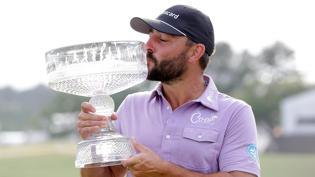 AP : Stephan Jaeger kisses the trophy as he poses for photos during ceremonies after his win in the final round of the Houston Open golf tournament.