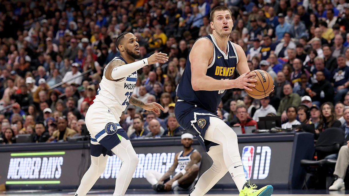 Nikola Jokic #15 of the Denver Nuggets drives against Monte Morris #23 of the Minnesota Timberwolves during the first quarter at Ball Arena on April 10, 2024. - File