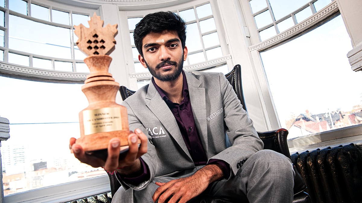 Indian Grandmaster D Gukesh poses with the trophy after winning the FIDE Candidates 2024 tournament in Toronto. - FIDE/Stev Bonhage