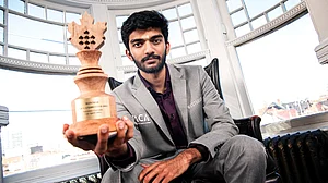 FIDE/Stev Bonhage : Indian Grandmaster D Gukesh poses with the trophy after winning the FIDE Candidates 2024 tournament in Toronto.