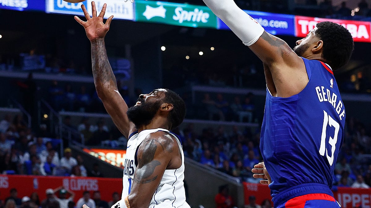 Paul George of the Los Angeles Clippers (right) defends a shot by Dallas Mavericks guard Kyrie Irving on April 21, 2024. - null