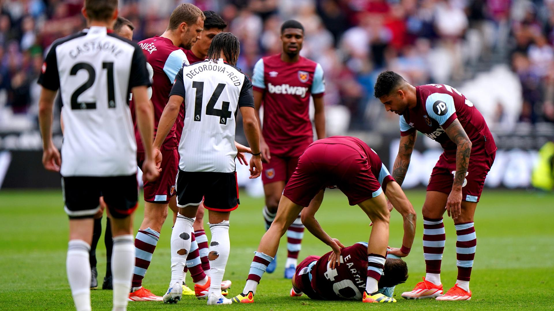 West Ham players come to the aid of team-mate George Earthy as he lies injured. - Bradley Collyer/PA