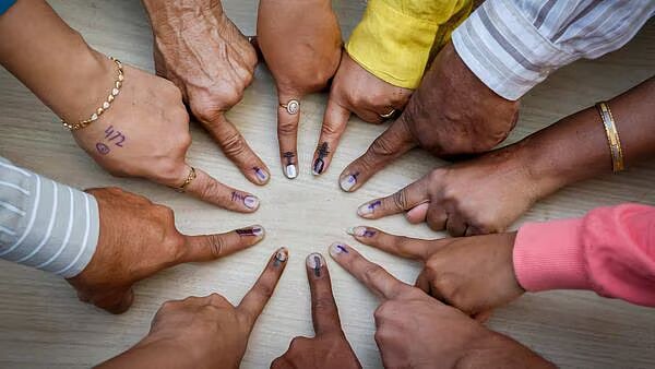 PTI : Voters gathered to take a picture of their inked fingers together after casting votes |