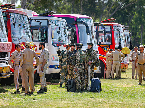 Security personnel wait to leave for election duty ahead of the 2nd phase of voting for Lok Sabha elections, in Jammu, Thursday, April 25, 2024.