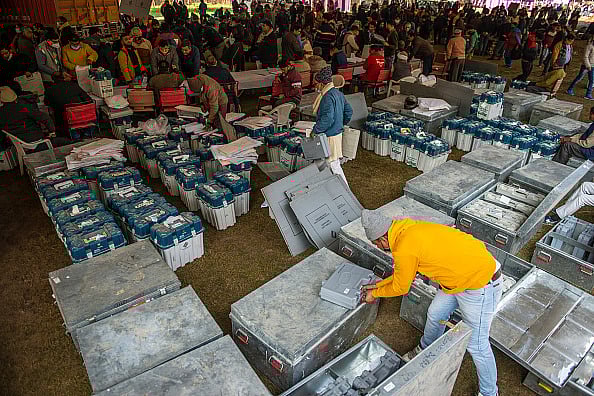 Getty Images  : Polling officials are seen distributing the Electronic Voting machines (EVM) and voter-verified paper audit trail (VVPAT) Ghaziabad