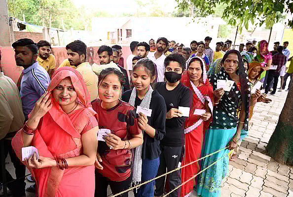 Getty Images : Women voters standing in queue to cast their votes during the local bodies election