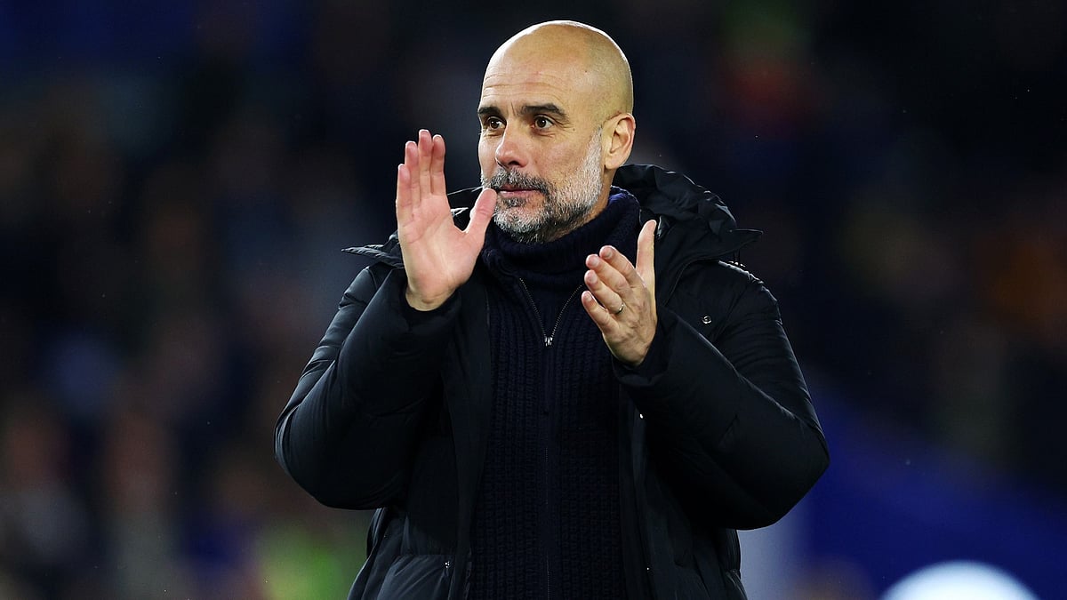 Pep Guardiola applauds Manchester City's fans after Thursday's win over Brighton. - null