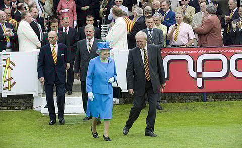 File photo of Britain's Queen Elizabeth II being led on to the field by then MCC president Derek Underwood, right, on July 17, 2009. England cricket great Derek Underwood died at age 78.