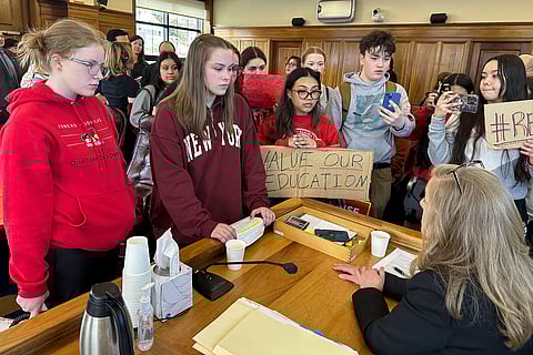 Meadow Stanley, far left, and Rachel Wood, second from left, are among the students speaking, Thursday, April 4, 2024, in Juneau, Alaska, with state Rep. Julie Coulombe about why she did not vote to override the governor's veto of an education package last month.