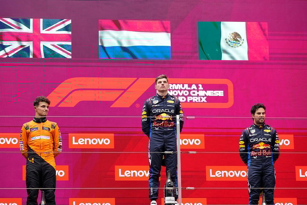(AP Photo)
 : Winner Red Bull driver Max Verstappen of the Netherlands, center, listens to his national anthem flanked on the podium with second placed McLaren driver Lando Norris of Britain, left, and third Red Bull driver Sergio Perez of Mexico after the Chinese Formula One Grand Prix at the Shanghai International Circuit, Shanghai, China, Sunday, April 21, 2024. 

