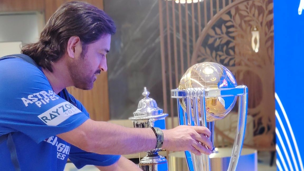 MS Dhoni posing with the 2011 ODI WC trophy. - X/BCCI