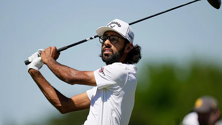 Akshay Bhatia watches his tee shot on the fourth hole during the first round of the Texas Open golf tournament. - Eric Gay/AP