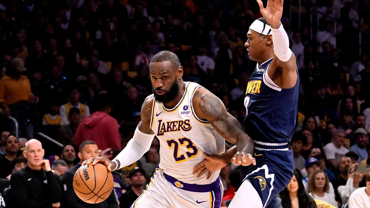 LeBron James #23 of the Los Angeles Lakers drives to the basket against Peyton Watson #8 of the Denver Nuggets in the first half of game 4 of a first round NBA playoff basketball game at Crypto.com Arena in Los Angeles on Saturday, April 27, 2024. - null