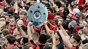 (Federico Gambarini/dpa via AP)
: Leverkusen's fans raise a mock champions trophy as they celebrate winning the German championship on the pitch after the Bundesliga soccer match between Bayer Leverkusen and Werder Bremen at the BayArena in Leverkusen, Germany, Sunday, April 14, 2024.