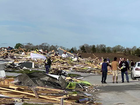 People pick through the rubble of a house that was leveled in Elkhorn, Neb., on Saturday, April 27, 2024. Residents began sifting through the rubble after a tornado plowed through suburban Omaha, demolishing homes and businesses as it moved for miles through farmland and into subdivisions.