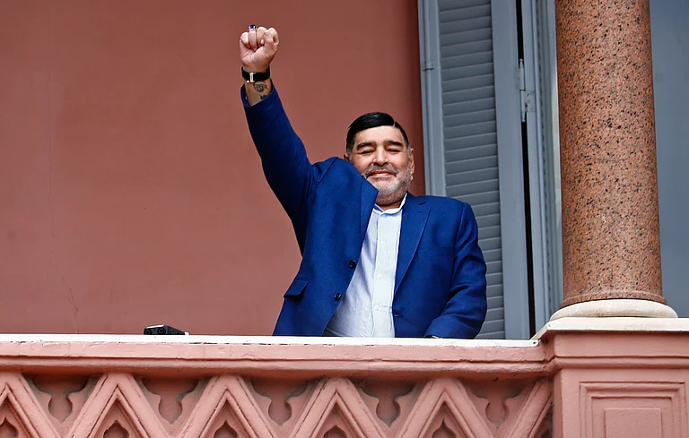 Diego Maradona acknowledges fans below at the Casa Rosada government house after his meeting with Argentine President Alberto Fernandez in Buenos Aires, Argentina on December 26, 2019. - Marcos Brindicci/AP