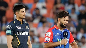 AP Photo/Pravin Indrekar : Delhi Capitals' captain Rishabh Pant, right, comments after he won the coin toss as Gujarat Titans' captain Shubman Gill looks on before the Indian Premier League cricket match between Delhi Capitals and Gujarat Titans in Ahmedabad.
