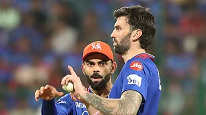 AP Photo/Kashif Masood : Royal Challengers Bengaluru's Virat Kohli speaks to bowler Reece Topley during the Indian Premier League cricket match between Royal Challengers Bengaluru and Sunrisers Hyderabad in Bengaluru.
