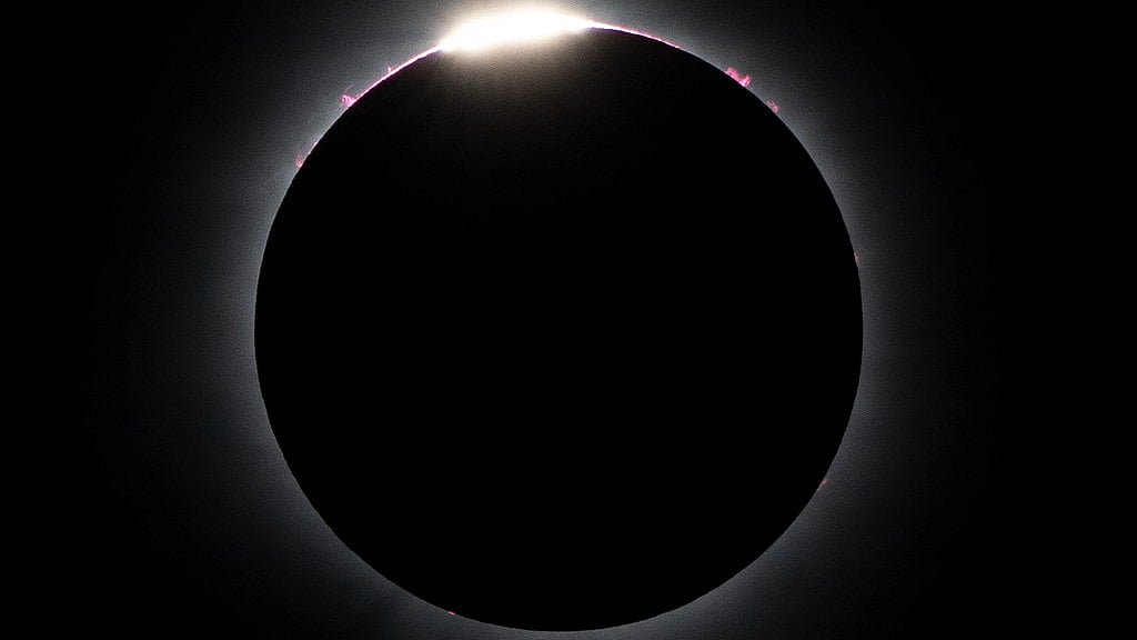 AP : The moon nearly covers the sun during a total solar eclipse, as seen from Bishop's University in Sherbrooke, Quebec.