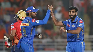 AP Photo/ Surjeet Yadav : Mumbai Indians' Jasprit Bumrah, right, and Mumbai Indians' Tilak Varma celebrate the dismissal of Punjab Kings' Shashank Singh during the Indian Premier League cricket match between Punjab Kings' and Mumbai Indians in Mullanpur.