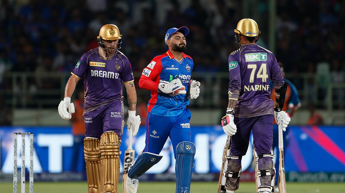 Delhi Capitals' captain and wicketkeeper Rishabh Pant, centre, runs to change the side after an over as Kolkata Knight Riders' Phil Salt and Sunil Narine walk, during Indian Premier League 2024 match between Delhi Capitals and Kolkata Knight Riders in Visakhapatnam. - AP Photo/ Surjeet Yadav