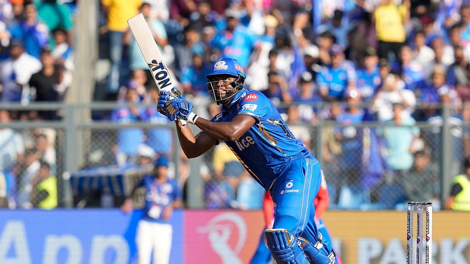 Mumbai Indians' Romario Shepherd plays a shot during the Indian Premier League cricket match between Mumbai Indians' and Delhi Capitals' in Mumbai, India, Sunday, April. 7, 2024. - AP