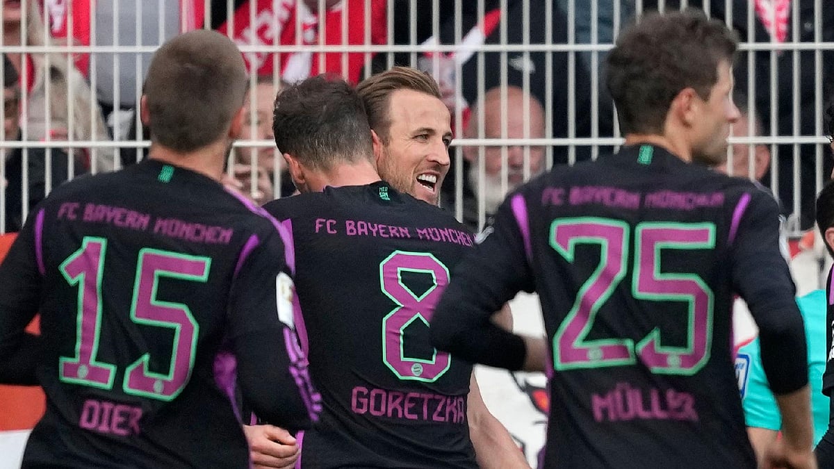 Ebrahim Noroozi/AP : Harry Kane is congratulated by team-mates after scoring for Bayern Munich.