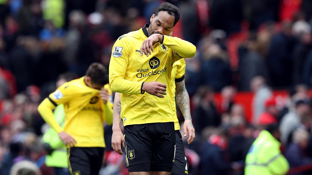 Joleon Lescott reacts after Aston Villa’s defeat at Manchester United confirmed their relegation. - Martin Rickett/PA