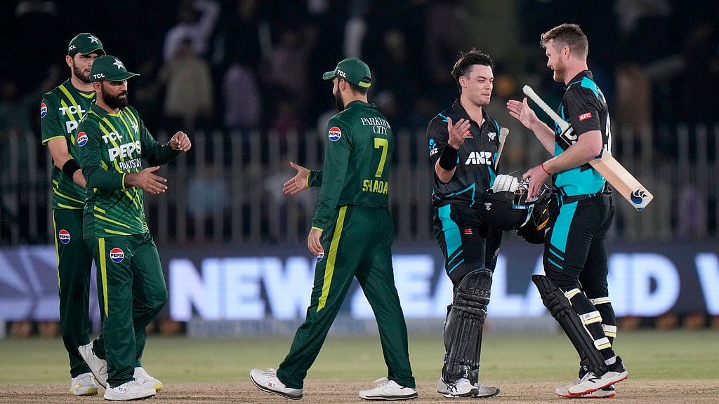 Photo: AP : Mark Chapman, second right, celebrates with James Neesham, right, after New Zealand beat Pakistan by seven wickets in the third T20I in Rawalpindi on Sunday, April 21, 2024. 