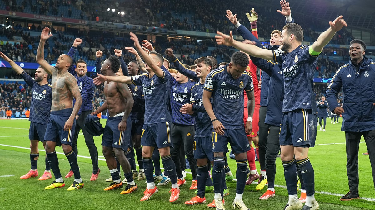 Real Madrid celebrate their triumph in front of supporters following the UEFA Champions League quarter-final second-leg football match against Manchester City. - AP