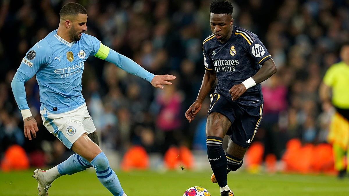 Manchester City's Kyle Walker fights for the ball with Real Madrid's Vinicius Junior (right) during the UEFA Champions League quarter-final, second leg match at the Etihad Stadium in Manchester. - AP