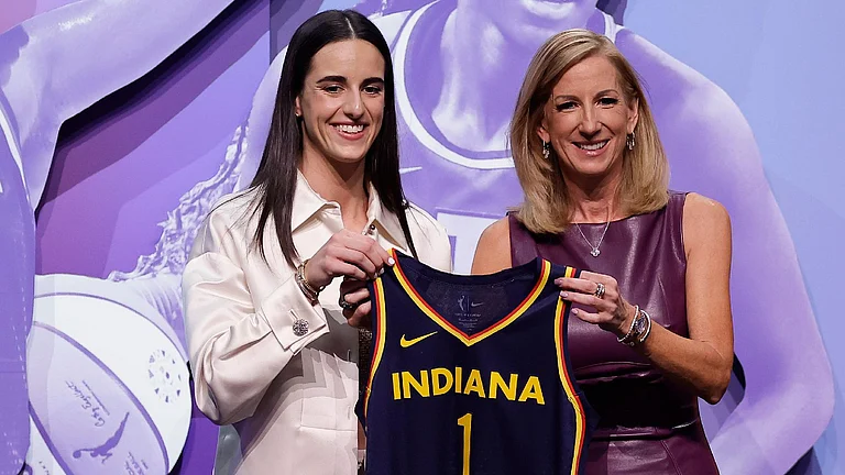 Caitlin Clark, left, poses for a photo with WNBA commissioner Cathy Engelbert after being selected first overall by the Indiana Fever during the first round of the WNBA draft. - Adam Hunger/AP